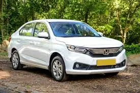 Honda Amaze taxi available for airport transfers and outstation cab booking in Amritsar, Dharamshala, Chandigarh, Ludhiana, and New Delhi.