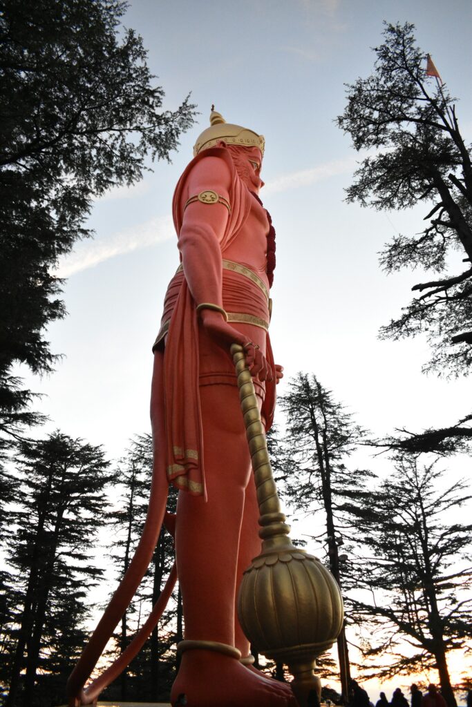 Beautiful aerial panorama of Shimla showing Jakhu Temple Hanuman statue and surrounding Himalayan hills