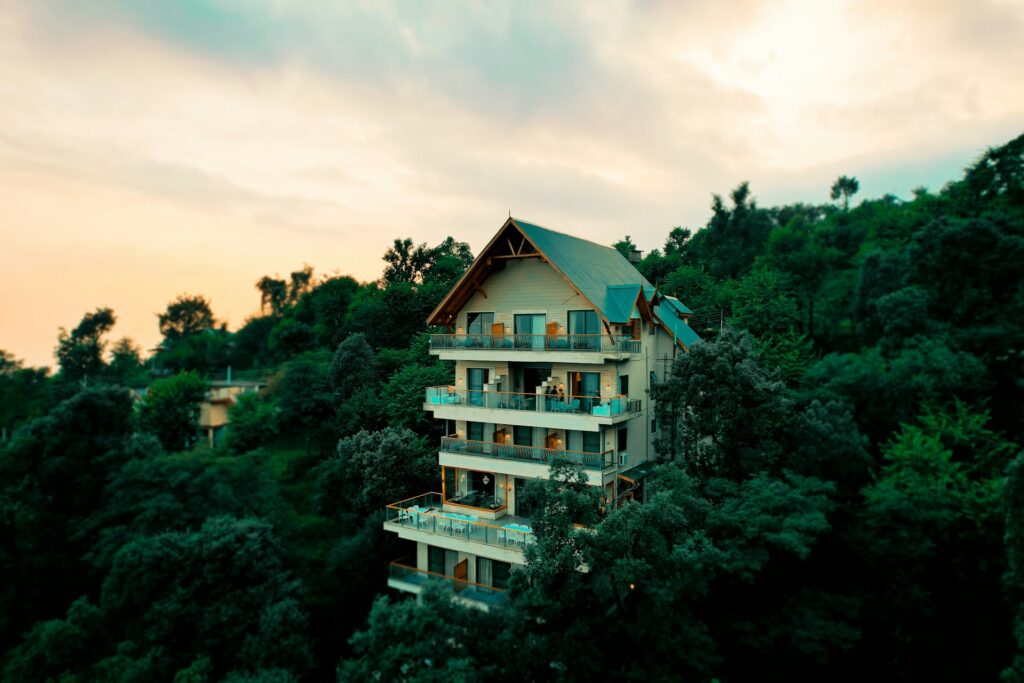 Beautiful six-story hotel in McLeod Ganj surrounded by lush green mountains and trees