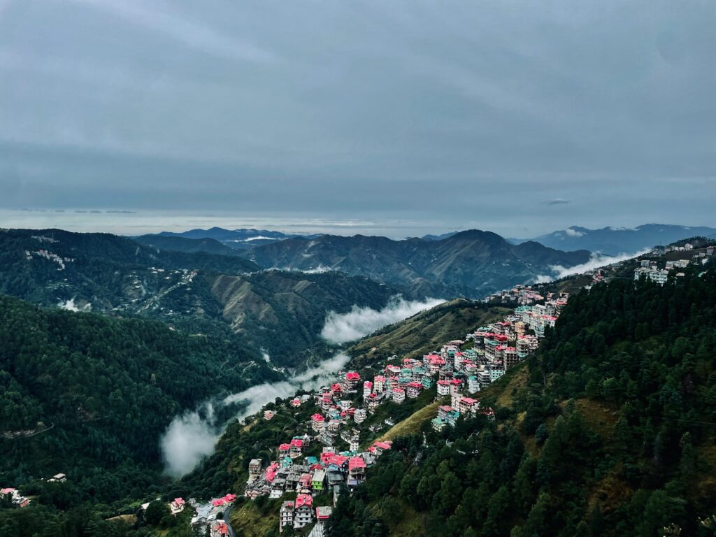 Panoramic Shimla mountain valley view with houses and greenery in Himachal Pradesh