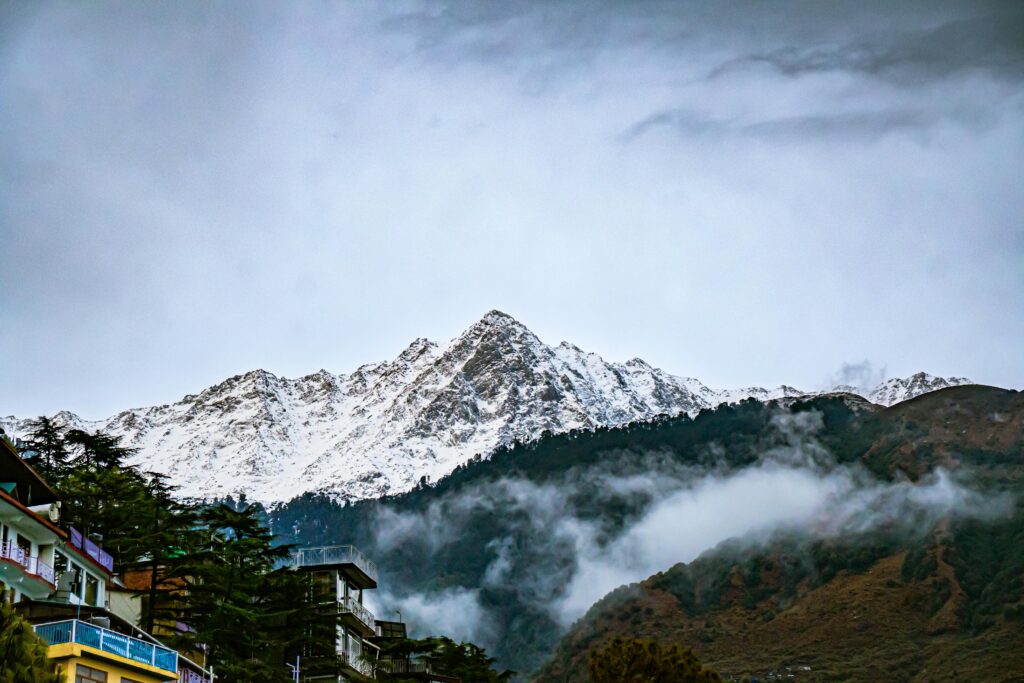 Snow-covered Dhauladhar mountain peaks near Dharamshala showcasing the breathtaking Himalayan landscape for travelers exploring Himachal Pradesh with Visit Taxi Service from Amritsar, Chandigarh, Ludhiana, New Delhi and Jalandhar.